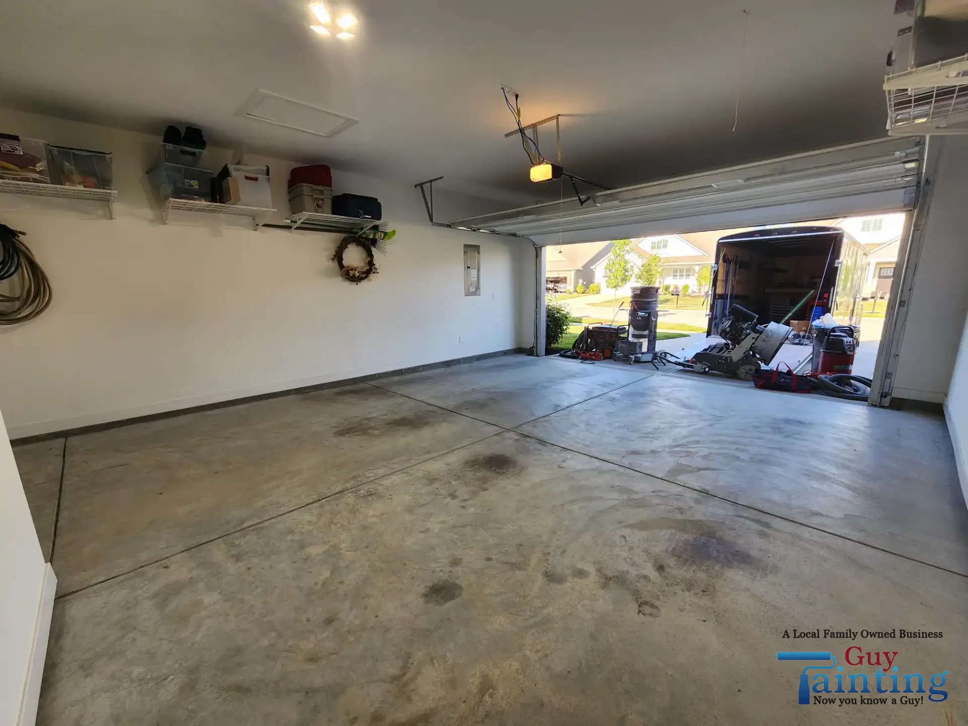Stained, dusty concrete garage floor before Color Tidal Wave coating, area 3