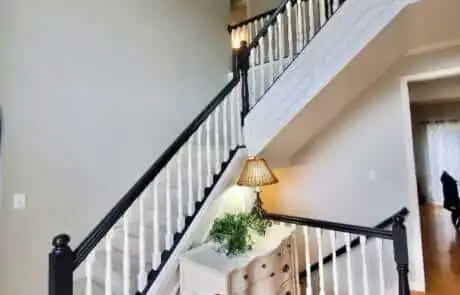 Foyer with freshly painted white banister and staircase