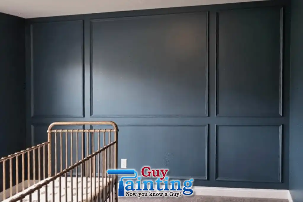 Nursery interior after painting by Guy Painting — deep navy accent wall with box trim