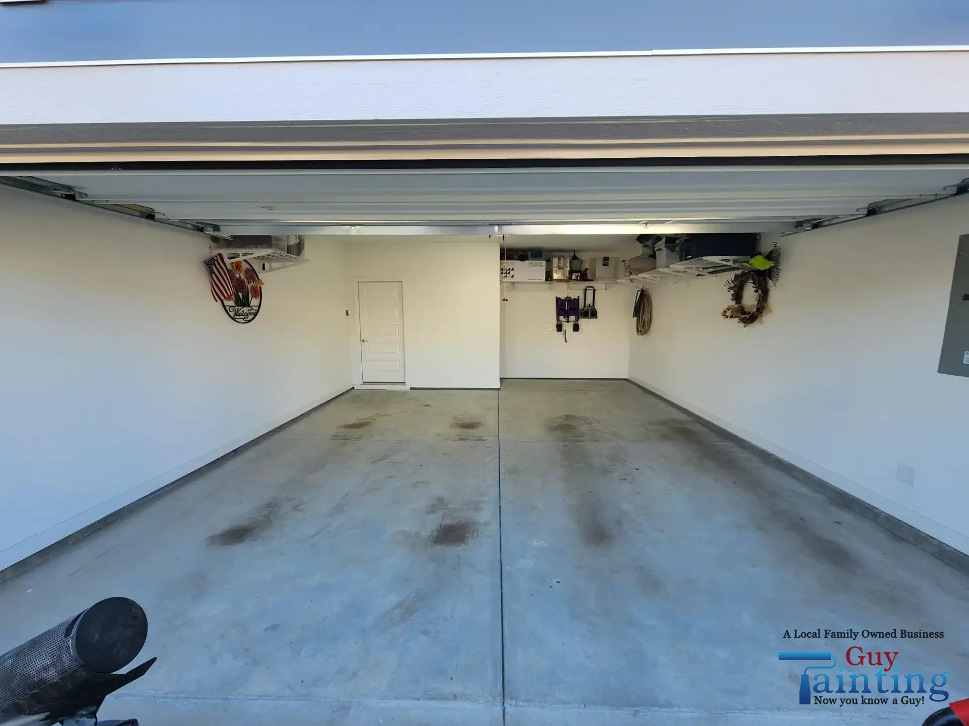 Stained, dusty concrete garage floor before Color Tidal Wave coating, area 1