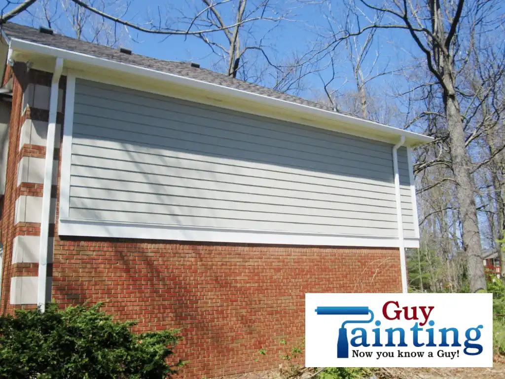 Freshly installed and painted gutterboard and siding after Guy Painting replacement