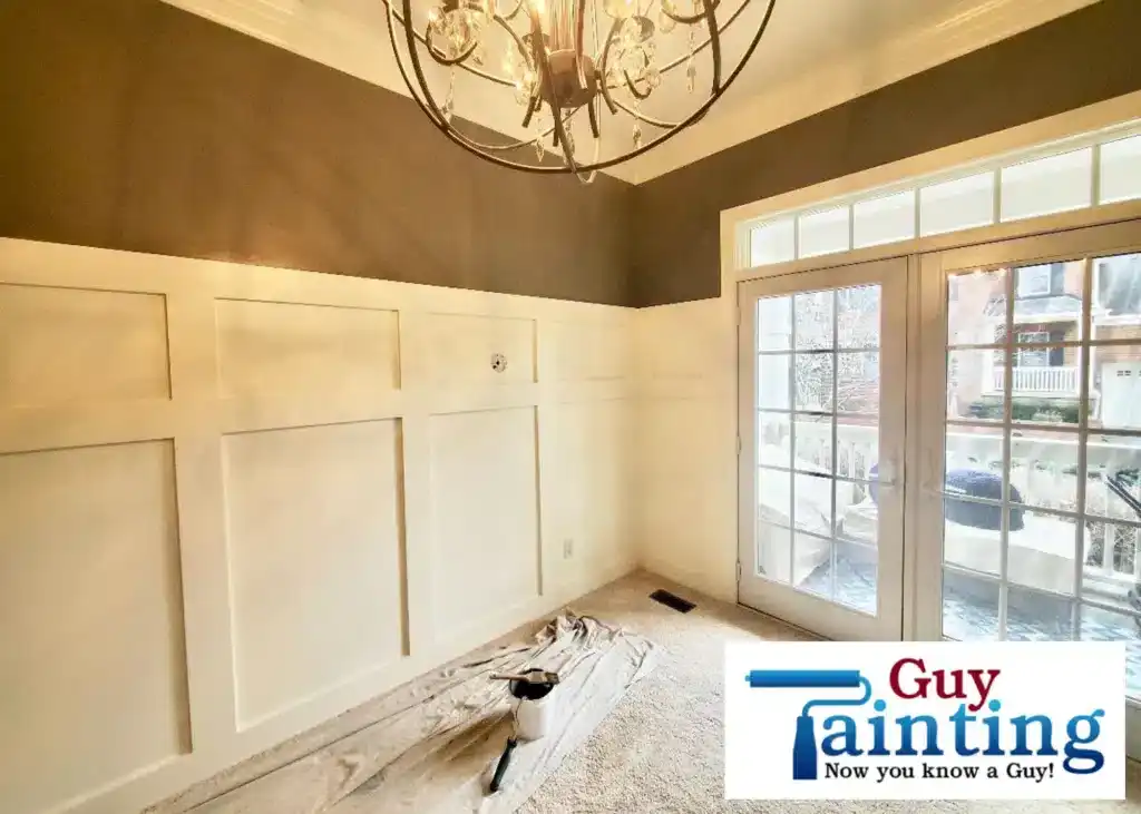 Dining room with tall white judge's paneling and warm brown upper walls