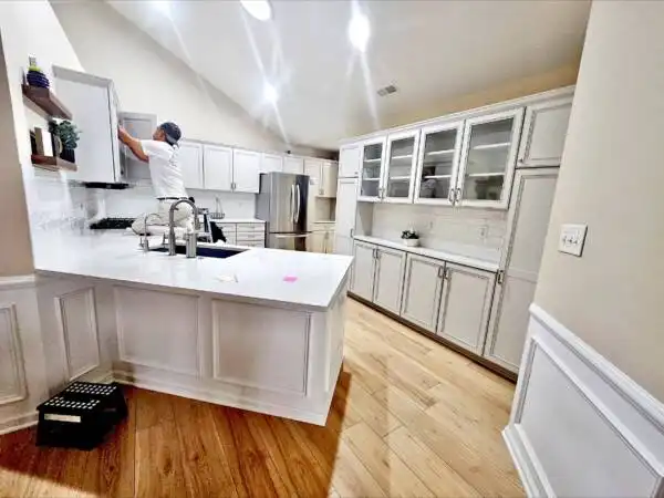 Modern kitchen with crisp white painted cabinets and white backsplash