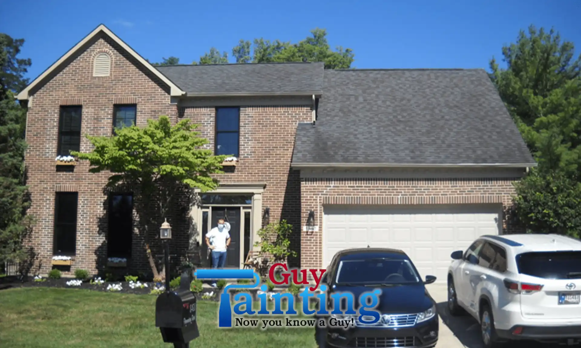 Geist home exterior with original red brick and tan garage door, before painting