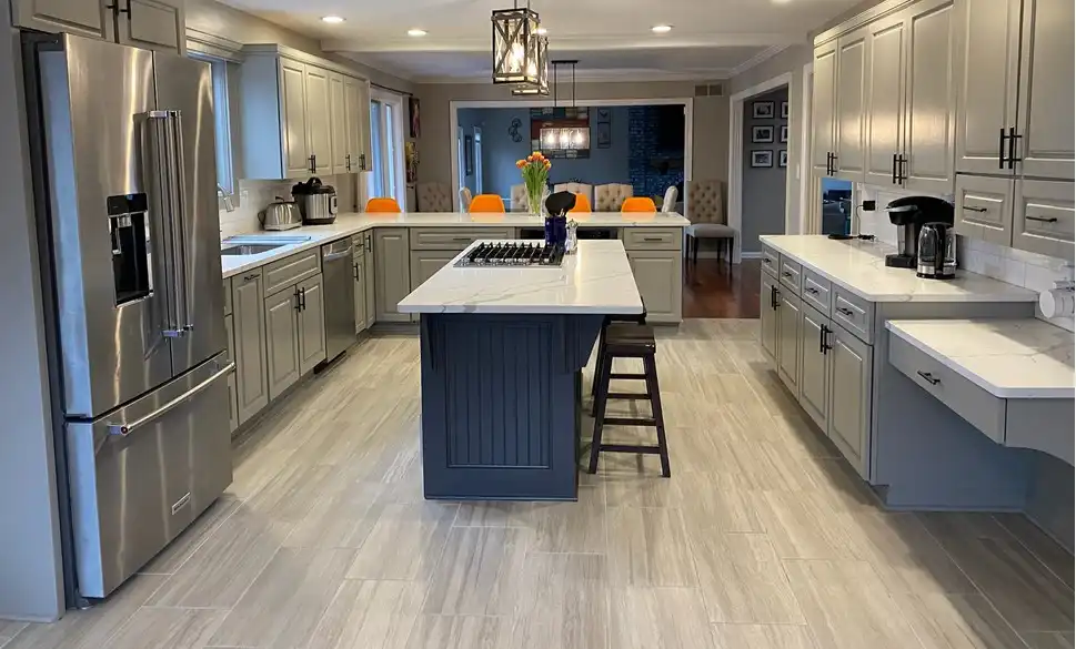 Kitchen in a Geist home painted in Sherwin-Williams Dorian Gray cabinets with a Peppercorn island and Repose Gray walls by Guy Painting